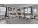 Comfortable living room featuring two sofas, a fireplace and neutral tones at 7860 Sergi Canyon Dr, Indianapolis, IN 46217