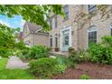 Inviting entryway featuring a decorative front door, manicured shrubs, and beautiful landscaping at 8181 Fairway Dr, Brownsburg, IN 46112