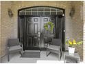 Inviting front entrance with a black double door, decorative wreath, and seating at 8324 Thorn Bend Dr, Indianapolis, IN 46278