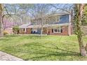 Beautiful two-story home with brick and blue siding and a well-maintained lawn, framed by mature trees at 8639 Lancaster Rd, Indianapolis, IN 46260