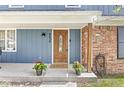 Inviting front porch with decorative flowers flanking an ornate front door, adding a touch of warmth at 8639 Lancaster Rd, Indianapolis, IN 46260