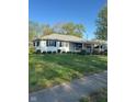Classic single-story home with a well-kept lawn and landscaping plus convenient covered parking on the right at 929 Delman Dr, Shelbyville, IN 46176