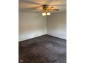 A blank canvas living room awaits your personal touch, featuring neutral walls and carpet plus vintage ceiling fan at 929 Delman Dr, Shelbyville, IN 46176