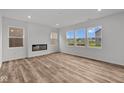 Bright living room with wood-look flooring, large windows, and a modern fireplace at 10138 Redwood Peak Ln, Indianapolis, IN 46259