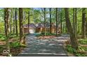 Beautiful brick home with lush surrounding trees and a long driveway leading to the property at 10561 Wilson Rd, Brownsburg, IN 46112