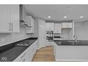 Well-lit kitchen featuring white cabinets, granite countertops, and stainless steel appliances at 1114 Ridgevine Rd, Greenwood, IN 46143