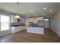 A spacious kitchen with white cabinets, stainless steel appliances, and hardwood floors at 1114 Ridgevine Rd, Greenwood, IN 46143
