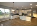 Stylish kitchen with white cabinets, stainless steel appliances, and hardwood floors at 1114 Ridgevine Rd, Greenwood, IN 46143