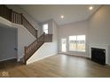 Bright living room features tall ceilings, hardwood floors, and a cozy fireplace at 1114 Ridgevine Rd, Greenwood, IN 46143