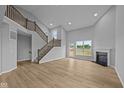 Bright, open living room with a fireplace, large windows, and a staircase at 1114 Ridgevine Rd, Greenwood, IN 46143