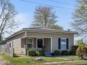 Inviting home with covered porch, stone accents, and a well-maintained, lush green lawn at 125 W Noble St, Lebanon, IN 46052