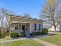 Cozy home showcasing a manicured lawn, inviting porch, and classic architectural details at 125 W Noble St, Lebanon, IN 46052