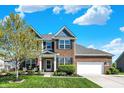 Beautifully landscaped two-story home with a brick facade, manicured lawn, and inviting curb appeal at 13836 Fieldcrest Dr, McCordsville, IN 46055