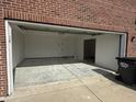 Attached two-car garage featuring concrete flooring, bright lighting, and interior access door at 1539 Egret Ln, Greenwood, IN 46143