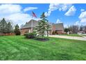 Well maintained home featuring lush green grass, an American flag, and a basketball hoop at 16 Cattail Ln, Brownsburg, IN 46112