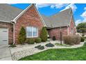 Charming single-Gathering home featuring a brick exterior, mature landscaping, and a paved walkway at 16 Cattail Ln, Brownsburg, IN 46112