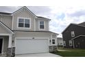 Exterior of new construction home with a two-car garage and gray accents at 16830 Silo Meadows Dr, Noblesville, IN 46060
