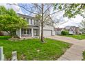 Landscaped front yard features beautiful green grass and a well maintained driveway with a basketball hoop at 18980 Bladed Mills Dr, Noblesville, IN 46062