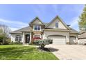 Attractive single-Gathering home with a well-kept lawn, mature landscaping, and a three-car garage at 19311 Morrison Way, Noblesville, IN 46060