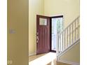 Bright entryway featuring hardwood floors, a staircase, and a stylish front door at 2020 Tourmaline Dr, Westfield, IN 46074