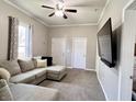 Cozy living room featuring a comfortable sectional sofa, neutral paint and carpet, and a ceiling fan at 2022 Indiana Ave, Columbus, IN 47201