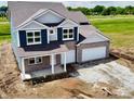 Aerial view of a charming two-story home with a spacious two-car garage at 210 Aster Way, Greenfield, IN 46140