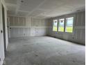 A large, unfinished living room with bright windows at 210 Aster Way, Greenfield, IN 46140
