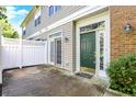 Welcoming townhouse entry with a green front door, a fenced patio, and access via a sliding door at 2270 Brightwell Pl, Indianapolis, IN 46260