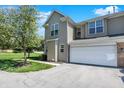 Attractive townhouse with a two-car garage, a well-maintained lawn, and charming curb appeal at 2270 Brightwell Pl, Indianapolis, IN 46260