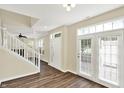 Bright foyer with wood floors, white staircase, and a door to the backyard at 2270 Brightwell Pl, Indianapolis, IN 46260