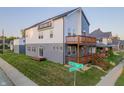 Striking exterior showcasing a two-story home with modern design, wooden balcony, and street views at 2302 Prospect St, Indianapolis, IN 46203