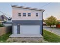 Detached two-car garage features a white door, modern design, and gray and white exterior paint at 2302 Prospect St, Indianapolis, IN 46203