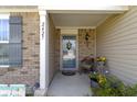 Inviting porch with a cozy seat, decorative wreath, and cheerful flower pots that enhance the home's curb appeal at 2427 Apple Tree Ln, Indianapolis, IN 46229