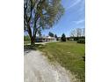 Spacious home with a wrap-around porch, detached garage, lush lawn, and ample greenery at 3333 S Sr 9, Greenfield, IN 46140