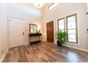 Inviting entryway with wood-look flooring, modern decor, and natural light from large windows at 3413 Putter Pl, Columbus, IN 47203