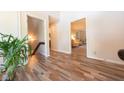 Hallway featuring stylish flooring, views to the living room, and access to stairs and other rooms at 3413 Putter Pl, Columbus, IN 47203