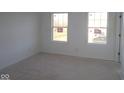 Bright, unfinished bedroom with two windows offering natural light, ready for your personal design at 3832 Highcrest Rd, Indianapolis, IN 46239