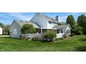 View of the white home's backyard with a covered patio and a white picket fence at 4243 Bay Leaf Cir, Indianapolis, IN 46237