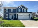 Two-story home with a two-car garage, dark siding, white trim, and a well-manicured lawn at 4245 W Fork Dr, Westfield, IN 46062