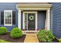 Charming front door with a wreath, beautiful landscaping, and a welcoming entrance at 4245 W Fork Dr, Westfield, IN 46062