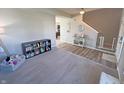 Open living area with vinyl flooring and neutral carpet with a staircase and open view to another room at 4245 W Fork Dr, Westfield, IN 46062