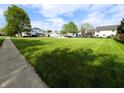 Expansive green lawn in a quiet neighborhood, showcasing a sense of community and open space at 4335 River Rd, Columbus, IN 47203