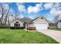 Charming single-story home with a well-maintained lawn and attached two-car garage at 4511 Hunt Master Ct, Indianapolis, IN 46268