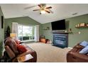Inviting living room featuring a fireplace, vaulted ceiling, and ample natural light at 4511 Hunt Master Ct, Indianapolis, IN 46268
