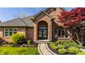Elegant brick home with a detailed front entrance and professional landscaping at 5872 Lake Kessler Ct, Indianapolis, IN 46226