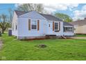 Charming one-story house with a well-maintained lawn and appealing light colored siding at 600 Alexandria Pike, Anderson, IN 46012