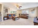 Inviting living room with neutral tones, comfortable seating, and plenty of natural light from large windows at 6211 W Bayfront Shores, McCordsville, IN 46055