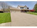 Beautiful two-story home with a well-maintained lawn and a spacious driveway leading to a three-car garage at 6220 Yellow Birch Ct, Avon, IN 46123