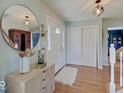 Bright foyer with hardwood floors, a decorative mirror, and a closet for convenient storage at 6220 Yellow Birch Ct, Avon, IN 46123