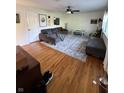 Bright living room featuring hardwood floors, stylish area rug, and comfortable seating at 6226 Fairlane Dr, Indianapolis, IN 46259